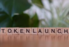 Scrabble tiles spelling 'Token Launch' on a vibrant green background.
