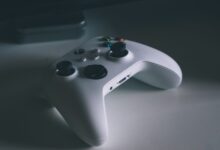 A detailed shot of a white gaming controller on a desk surface, perfect for tech and gaming themes.