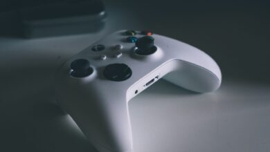 A detailed shot of a white gaming controller on a desk surface, perfect for tech and gaming themes.