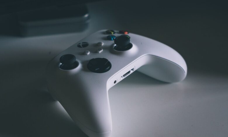 A detailed shot of a white gaming controller on a desk surface, perfect for tech and gaming themes.