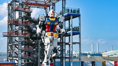 Life-sized Gundam robot at Gundam Factory Yokohama, Japan, in vibrant exterior daylight.