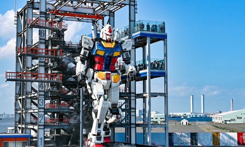 Life-sized Gundam robot at Gundam Factory Yokohama, Japan, in vibrant exterior daylight.