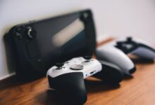 Stylish setup of gaming controllers and console on wooden surface.