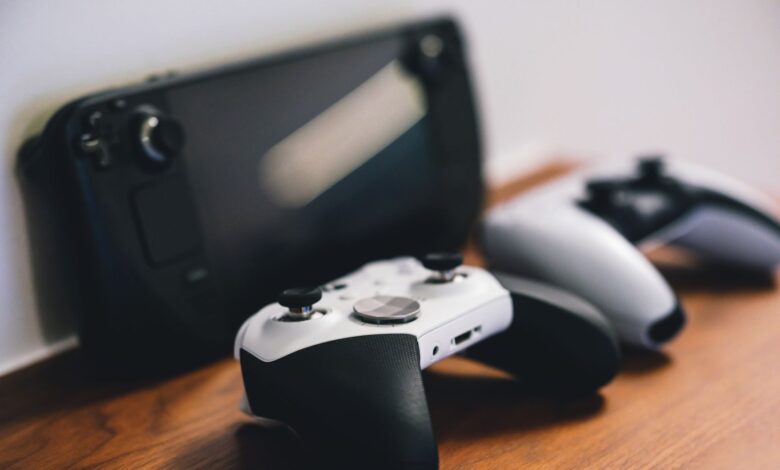 Stylish setup of gaming controllers and console on wooden surface.