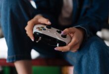 Hands holding a game controller during intense gameplay session.