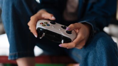Hands holding a game controller during intense gameplay session.