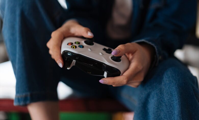Hands holding a game controller during intense gameplay session.