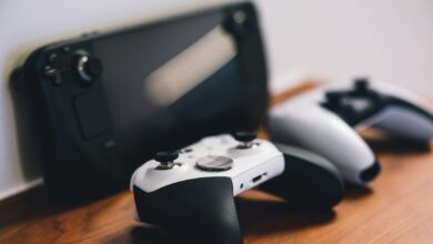 Stylish setup of gaming controllers and console on wooden surface.