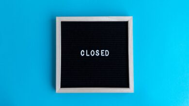 A letter board with 'Closed' displayed against a vibrant blue backdrop, signifying a closure or notice.