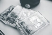 Close-up of collectible Pokemon cards in protective cases, emphasizing preservation and value.