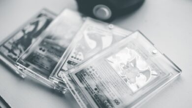 Close-up of collectible Pokemon cards in protective cases, emphasizing preservation and value.