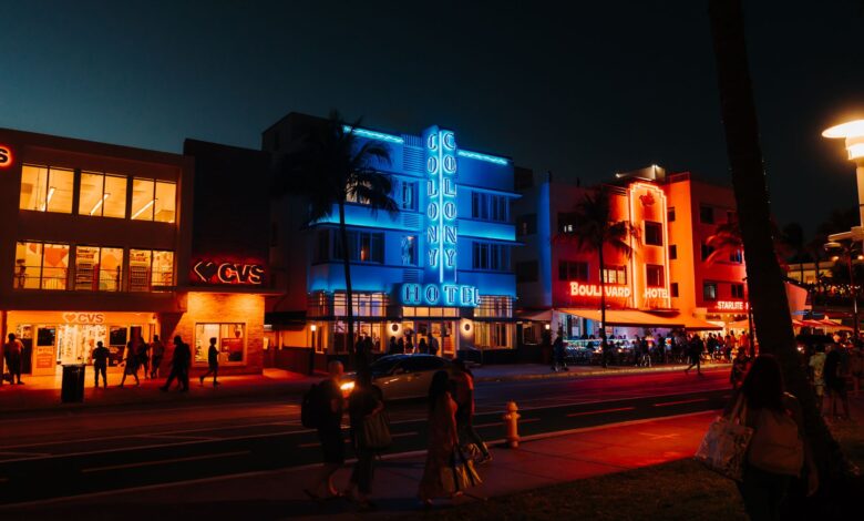 Colorful neon lights and lively street scene on Ocean Drive, Miami Beach, FL.