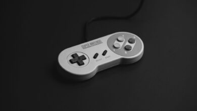 Close-up of a vintage Super Nintendo controller on a black background.