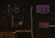A close-up view of a motherboard and electronic components against a detailed chalkboard backdrop.