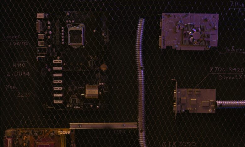A close-up view of a motherboard and electronic components against a detailed chalkboard backdrop.