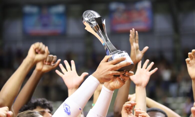 Group holds trophy in celebration, showcasing unity and achievement.