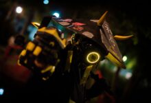 A person in neon cyberpunk costume poses dramatically at night.