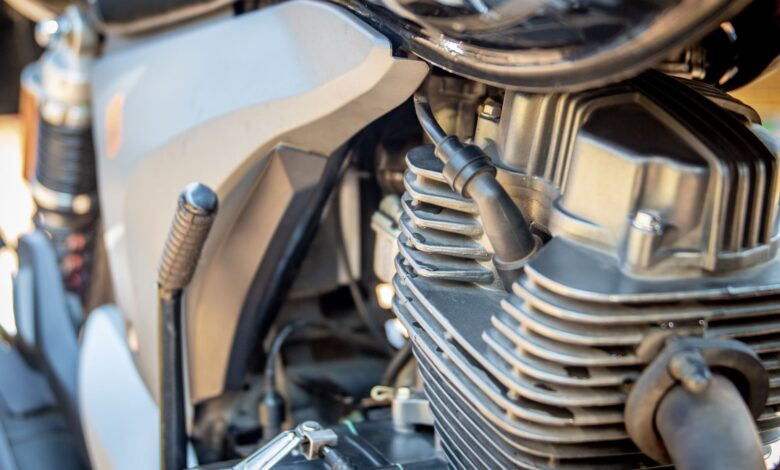 Detailed view of motorcycle engine, showcasing intricate mechanical parts. Ideal for automotive enthusiasts.