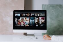 A modern workspace featuring a desktop screen displaying popular streaming series on Netflix.