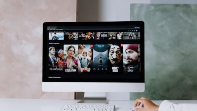 A modern workspace featuring a desktop screen displaying popular streaming series on Netflix.
