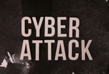 Text 'Cyber Attack' on textured dark paper highlights digital security threat concept.