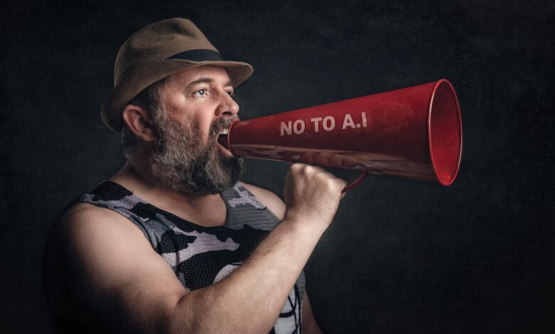 Bearded man shouting through a red megaphone with 'No to A.I' message.