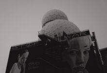 Black and white photo of anti-war mural on Teufelsberg Listening Station in Berlin, emphasizing peace.