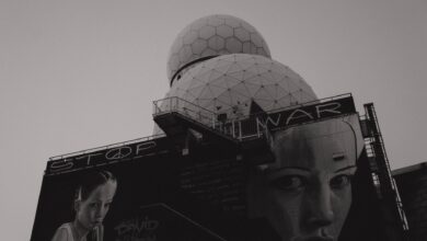 Black and white photo of anti-war mural on Teufelsberg Listening Station in Berlin, emphasizing peace.