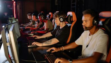 A group of focused young gamers playing in an intense esports tournament indoors.