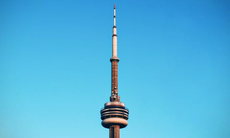 Close-up of Toronto's CN Tower reaching into a cloudless blue sky.