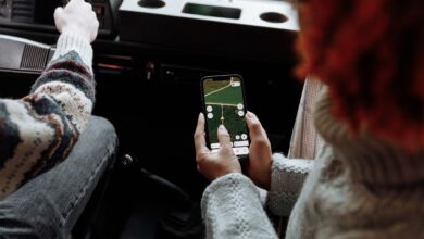 Two people using a navigation app on a smartphone during a road trip
