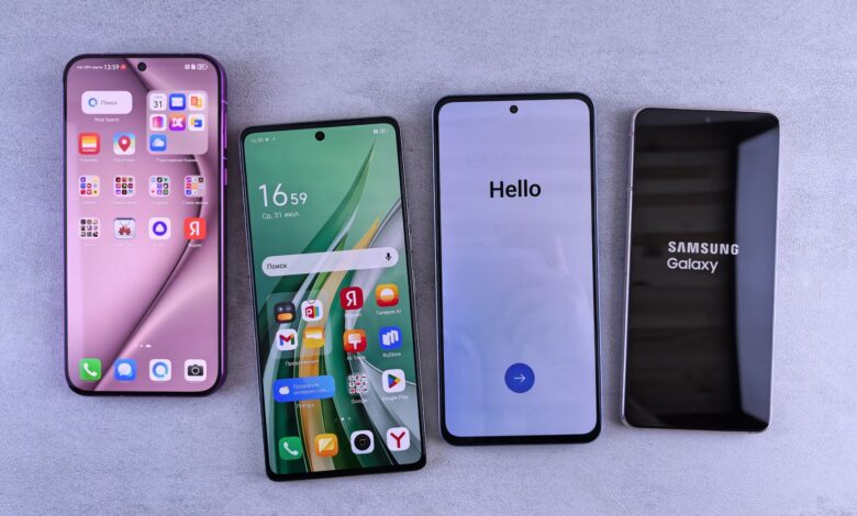 Four modern smartphones showcasing home screens, applications, and startup logos on a sleek surface.