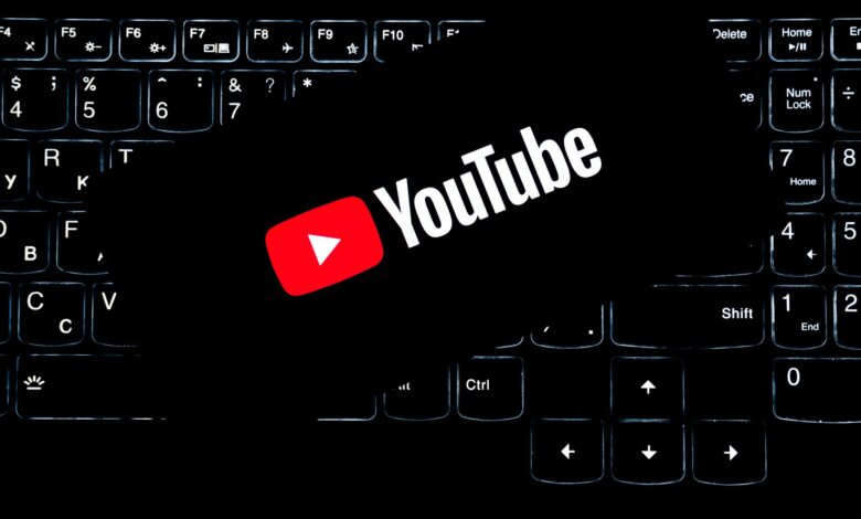 YouTube logo displayed on a backlit keyboard, representing digital media and online content creation.