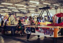Children and adults enjoy air hockey games in a lively indoor arcade setting.