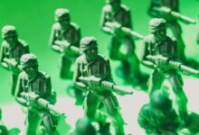 Detailed view of green plastic toy soldiers lined up in formation, symbolizing strategy and teamwork.