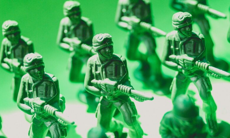 Detailed view of green plastic toy soldiers lined up in formation, symbolizing strategy and teamwork.