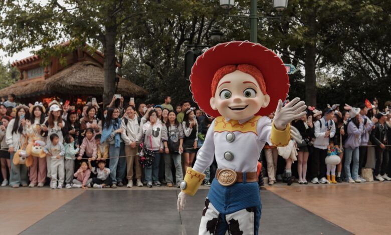 A vibrant Toy Story character parade at Shanghai Disneyland, featuring enthusiastic crowds and lively atmosphere.