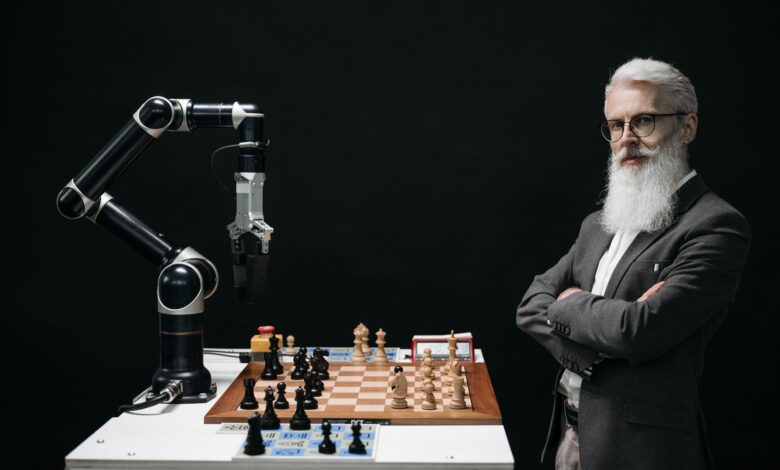 A robotic arm and a bearded man engaged in a strategic chess game highlighting technology and innovation.