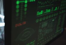 Close-up view of a computer displaying cybersecurity and data protection interfaces in green tones.