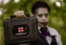 A cosplayer holding an Umbrella Corporation case, inspired by Resident Evil, ready for Halloween.
