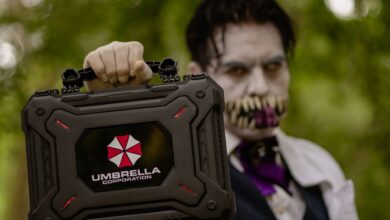A cosplayer holding an Umbrella Corporation case, inspired by Resident Evil, ready for Halloween.
