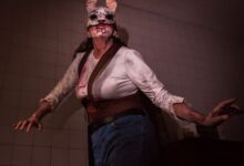 A person in a bloody rabbit mask costume poses ominously indoors, perfect for Halloween or horror themes.