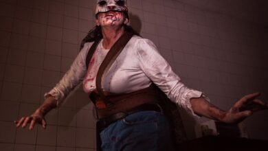 A person in a bloody rabbit mask costume poses ominously indoors, perfect for Halloween or horror themes.