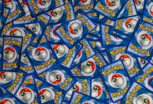 A vibrant collection of Pokemon trading cards featuring iconic Pokeball design and Pokemon logo.