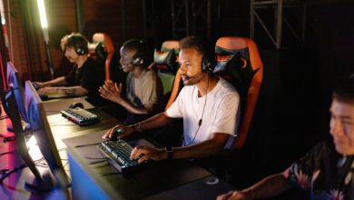 A group of young adults intensely focused on a competitive esports tournament indoors.