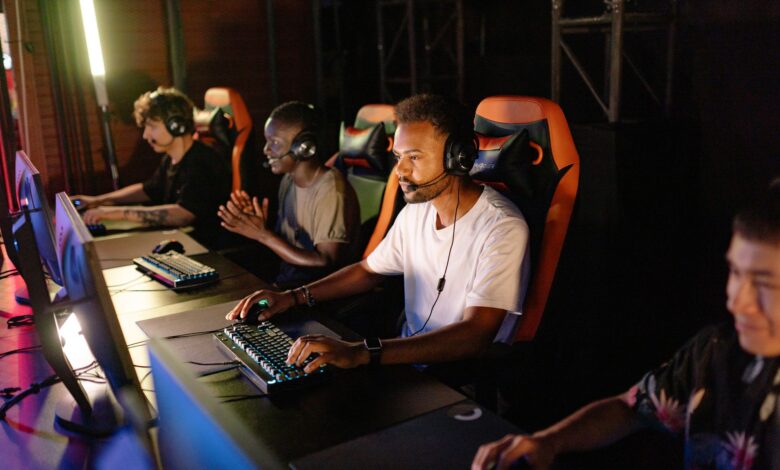A group of young adults intensely focused on a competitive esports tournament indoors.