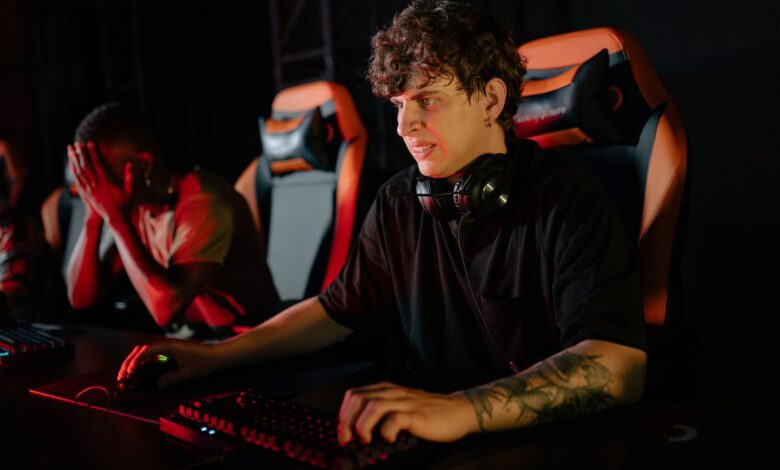 Focused gamers competing in a high-stakes eSports tournament with gaming chairs and headsets.