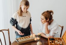 A mother and daughter engaged in puzzle-solving, enhancing creativity and bonding indoors.