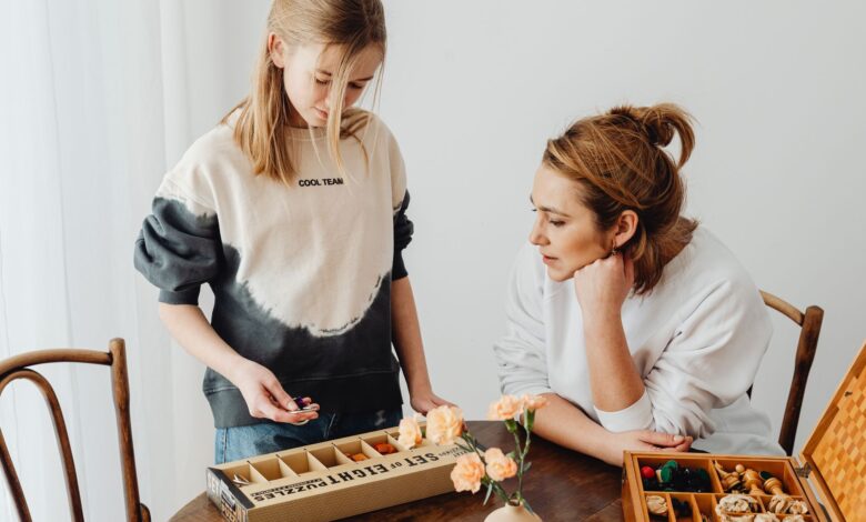 A mother and daughter engaged in puzzle-solving, enhancing creativity and bonding indoors.