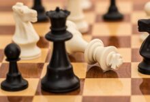 Close-up of chess pieces on a board depicting strategy and challenge.